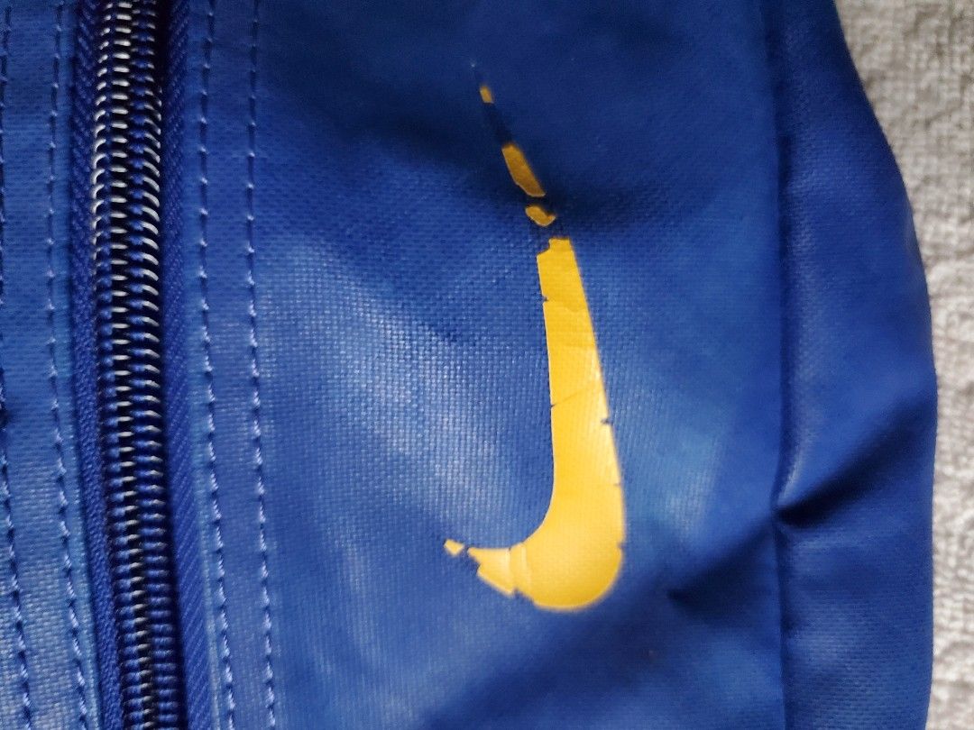 NIKE BLUE BELT BAG (Category: Belt bags, Clutches and Pouches) located in Manila. Submitted by smicolen (Listing ID 1459631338, Image 3). Description: - Blue Nike waist bag - Yellow Nike swoosh logo on front - Zipper closure - Adjustable strap with buckle - Dimensions: L 7", W 12 1/2", Bottom 2 1/2" - Ideal for carrying essentials on the go ISSUES: SIGN OF USAGE.
