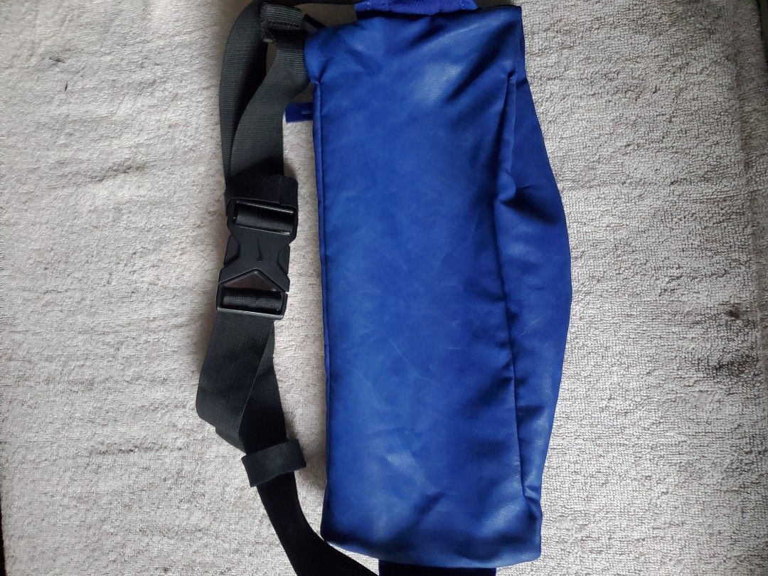 NIKE BLUE BELT BAG (Category: Belt bags, Clutches and Pouches) located in Manila. Submitted by smicolen (Listing ID 1459631338, Image 2). Description: - Blue Nike waist bag - Yellow Nike swoosh logo on front - Zipper closure - Adjustable strap with buckle - Dimensions: L 7", W 12 1/2", Bottom 2 1/2" - Ideal for carrying essentials on the go ISSUES: SIGN OF USAGE.