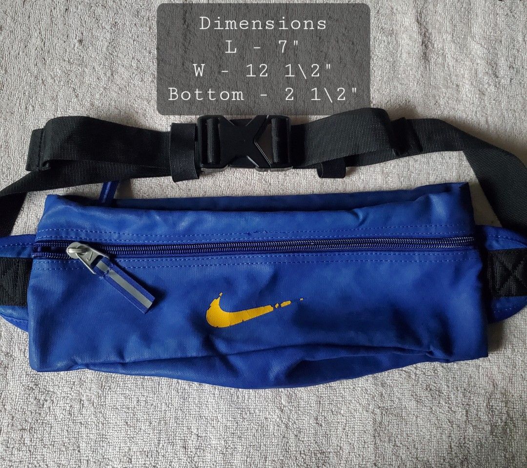 NIKE BLUE BELT BAG (Category: Belt bags, Clutches and Pouches) located in Manila. Submitted by smicolen (Listing ID 1459631338, Image 1). Description: - Blue Nike waist bag - Yellow Nike swoosh logo on front - Zipper closure - Adjustable strap with buckle - Dimensions: L 7", W 12 1/2", Bottom 2 1/2" - Ideal for carrying essentials on the go ISSUES: SIGN OF USAGE.