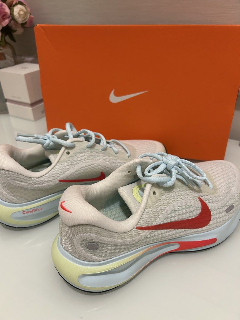 Nike ComfiRide Running Shoes (Category: Sneakers) located in Paranaque City. Submitted by pearlooosh (Listing ID 1459648572, Image 3). Description: - White Nike running shoes - Red and yellow accent colors - Light blue laces - Original Nike box included - Ideal for running and everyday wear - Comfortable and stylish design.