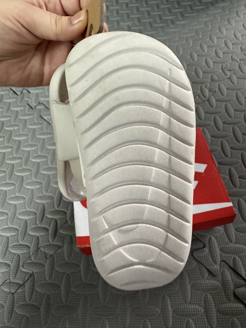 Nike Kawa Slide (TD) Phantom/Sanddrift White Gold (Category: Babies & Kids Fashion) located in Marikina City. Submitted by bangsfrancisco (Listing ID 1459520378, Image 2). Description: Pass as new - Nike Kawa Slides for kids - Color: White with Gold Nike Swoosh - Easy slip-on design - Ideal for beach days or everyday use - Includes original box and tags.