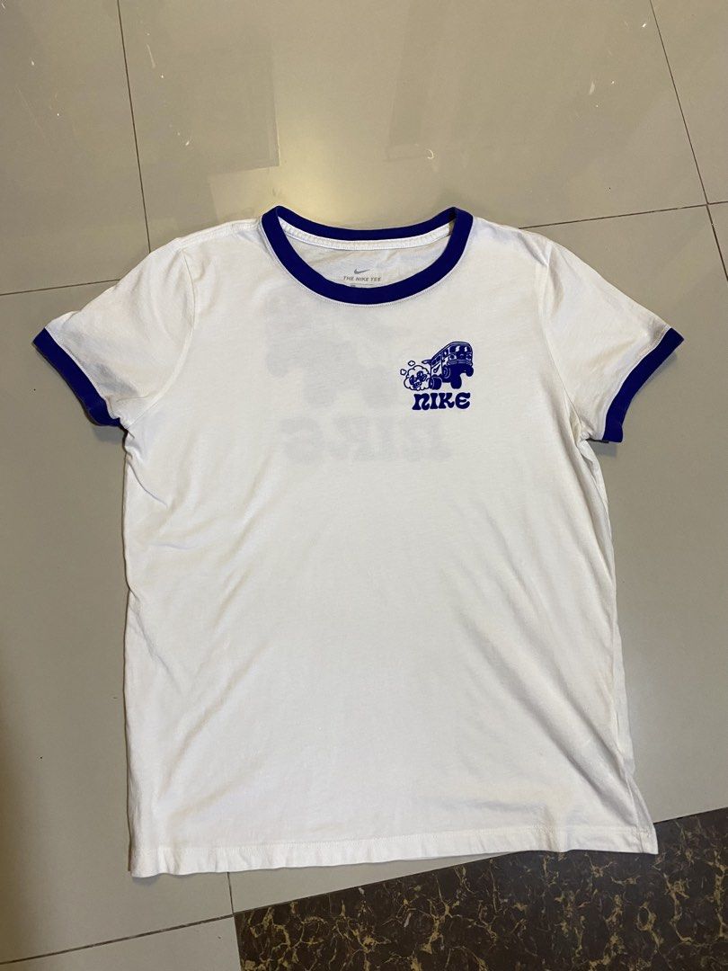 Nike Tee White Blue Graphic Print (Category: Tshirts & Polo Shirts ) located in San Jose. Submitted by .thrifty_finds (Listing ID 1459554881, Image 2). Description: - White Nike ringer tee with blue trim - Fun van and Nike logo graphic on the back - Smaller graphic on the front chest - Tag reads 'The Nike Tee' - Size: Large (L) - Material: 100% Cotton.