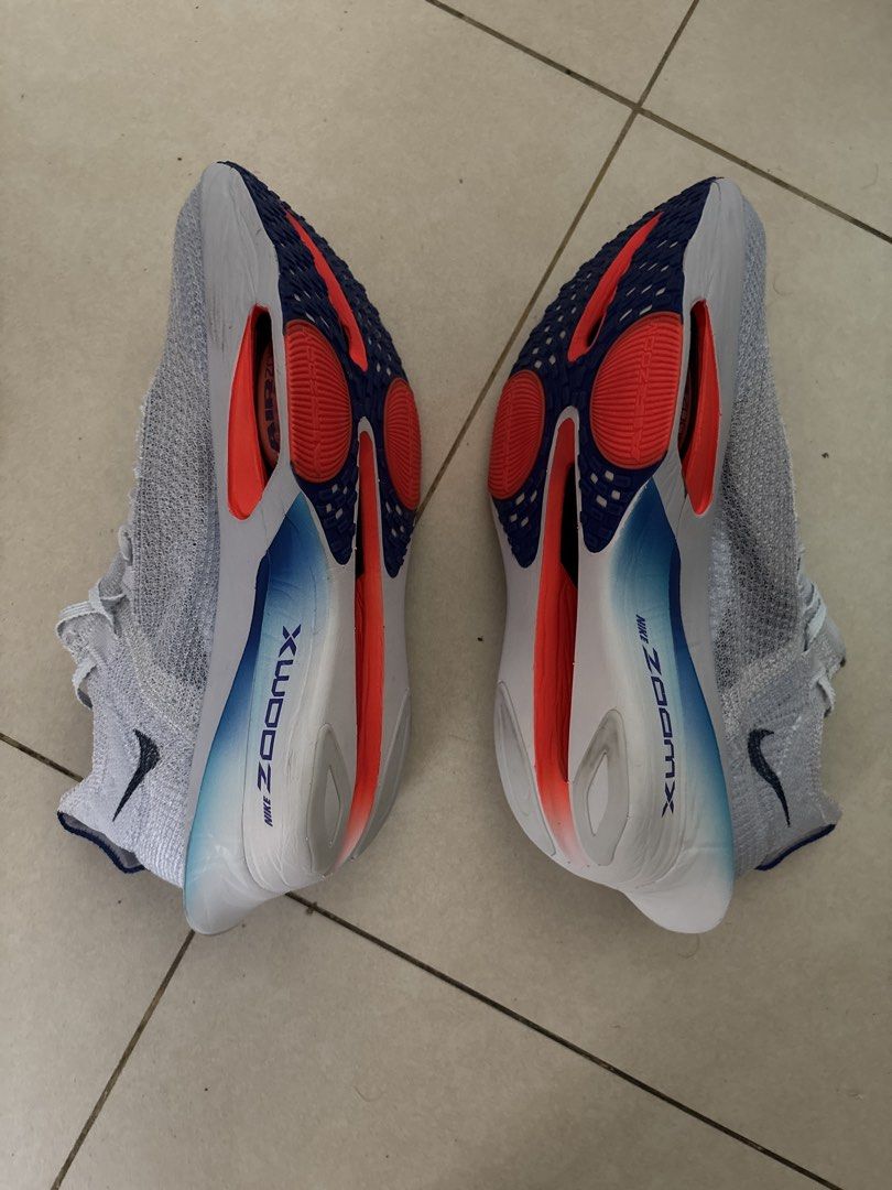 Nike ZoomX Alphafly NEXT% 3Running Shoes (Category: Sneakers) located in Pasig City. Submitted by ripescobar (Listing ID 1459513993, Image 3). Description: - Nike ZoomX Alphafly NEXT% 3 - Performance running shoes - Grey knit upper with navy and red accents - Comes with a mint green drawstring bag - Bag features EK logo and 'IT'S JUST THE START' text No original box, comes with dust bag.