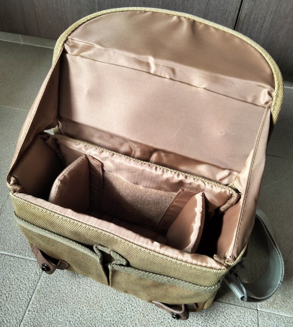Nikon Canvas Camera Bag with Strap (Category: Camera Bags & Carriers) located in Singapore. Submitted by sunsettosunrise (Listing ID 1459577458, Image 3). Description: - Tan canvas Nikon camera bag - Main compartment with adjustable dividers - Padded shoulder strap included - Nikon logo on front flap - Ideal for camera and accessories - Minor signs of wear. Not for the fuzzies..