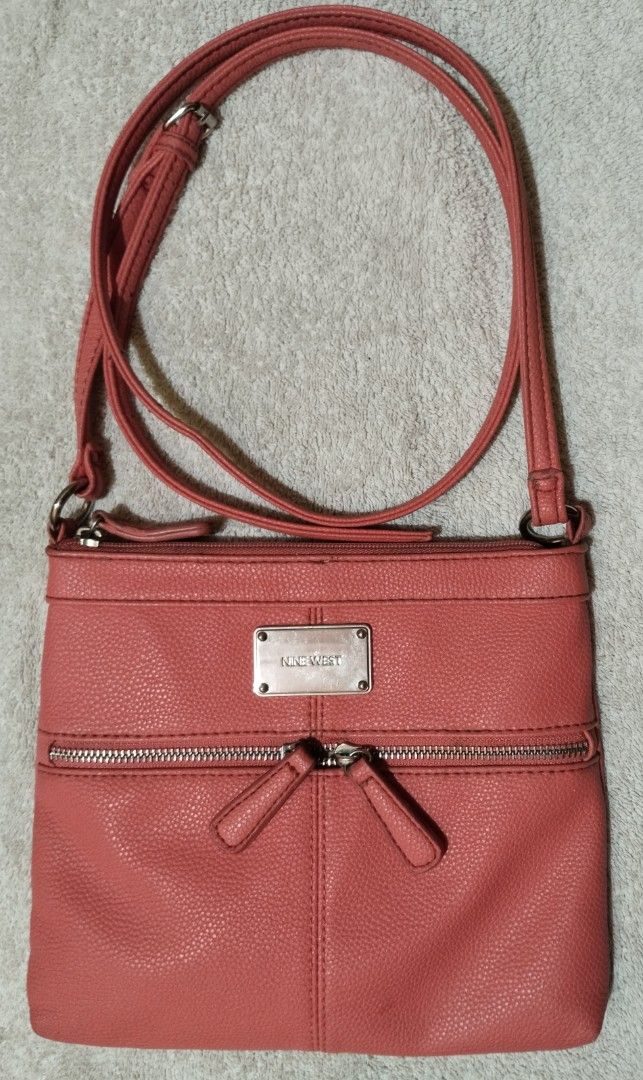 Nine West Coral Crossbody Bag (Category: Cross-body Bags) located in Quezon City. Submitted by genyc (Listing ID 1459617683, Image 1). Description: - Coral crossbody bag from Nine West - Two zippered pockets on the front - Adjustable strap for comfort - Ideal for everyday use - Spacious enough for your essentials.
