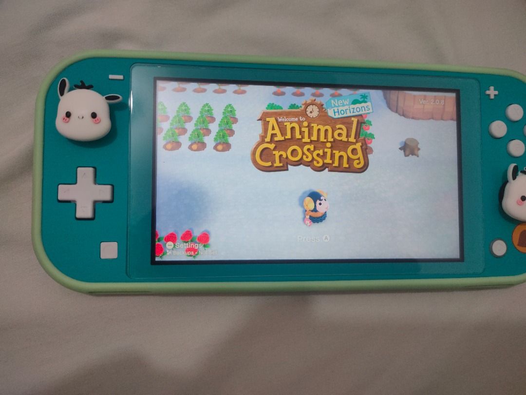 Nintendo switch lite w/ animal crossing (Category: Nintendo) located in Caloocan City. Submitted by kkduck1210 (Listing ID 1459648070, Image 2). Description: Nintendo switch lite special animal crossing version of the console with animal crossing game. Rarely used. Good condition with original charger, with screen protector and case .