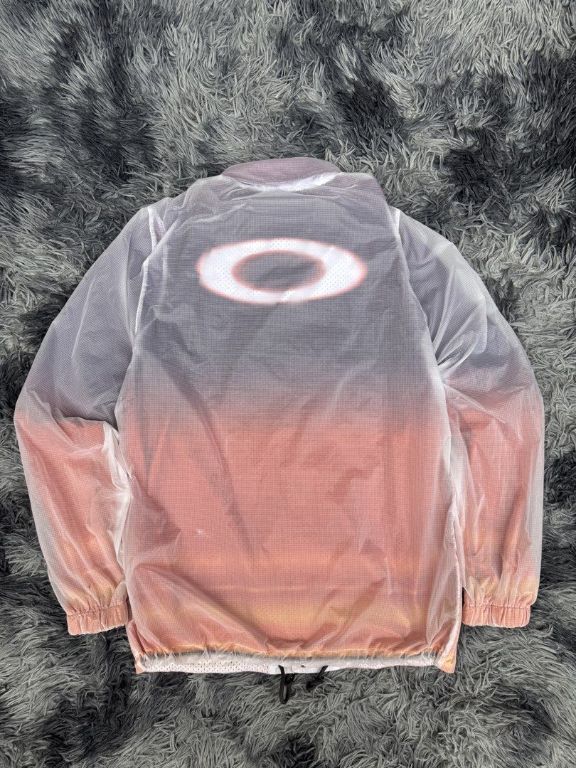 Oakley Custom Fit Windbreaker Jacket (Category: Coats, Jackets and Outerwear) located in Manila. Submitted by re_wear26 (Listing ID 1459568935, Image 3). Description: - Stylish Oakley windbreaker jacket - Cool white to pink ombre gradient - Oakley logo on front and back - Lightweight and perfect for layering - Button-up front with elasticated cuffs - Made in Taiwan.