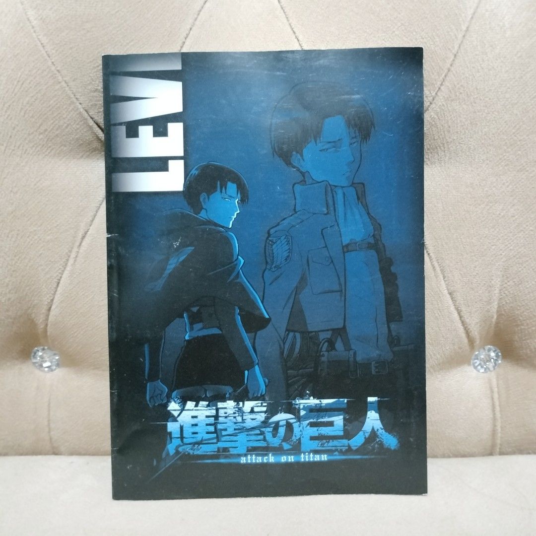 Official Merch Attack on Titan Levi Ackerman B5 Notebook (Category: Stationery & School Supplies) located in Imus. Submitted by viaysthriftshop (Listing ID 1459572383, Image 1). Description: ▪️Official Merch Attack on Titan Levi Ackerman B5 Notebook ▪️with very small crease on spine edge ▪️approx 10 inches X 7.5 inches ▪️ Featuring Captain Levi Ackerman ▪️Grid Pages ▪️Cute character prints along the bottom edge ▪️Perfect for notes, journaling, or