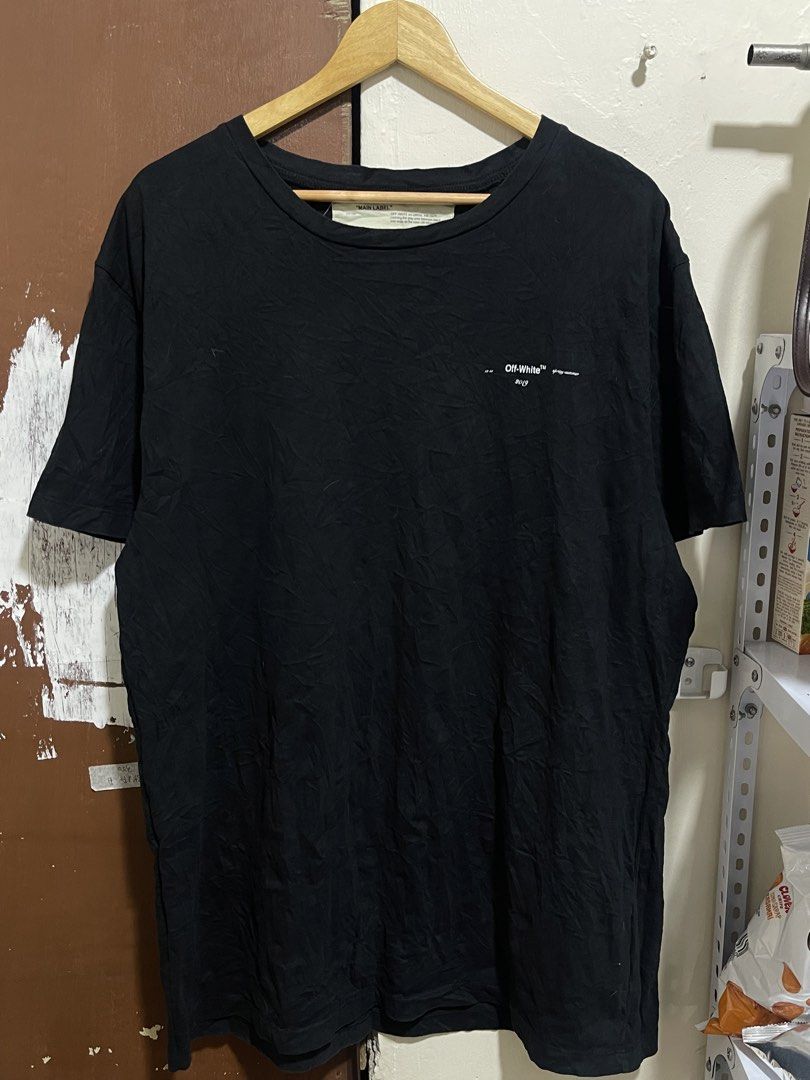 OFF-WHITE "MAIN LABEL" 2019 Black Graphic T-Shirt (Category: Tshirts & Polo Shirts ) located in Marikina City. Submitted by joshuaades21107 (Listing ID 1459620595, Image 2). Description: - Black OFF-WHITE T-shirt - From the 2019 Collection - Iconic OFF-WHITE arrows graphic on the back - 'spring-summer' detail on the front - 'MAIN LABEL' tag visible - 'OFF-WHITE c/o VIRGIL ABLOH' inner label - Ideal for streetwear enthusiasts 25 width 31 length .