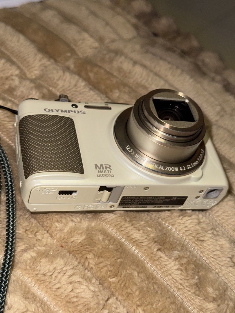 Olympus Stylus SH-25MR Digital Camera (Category: Cameras) located in Manila. Submitted by mysticbear.ad556f (Listing ID 1459597299, Image 3). Description: Key Specs: Sensor: 16 Megapixel, 1/2.3-inch Back-Illuminated CMOS Lens: 12.5x Wide Optical Zoom (4.2–52.5mm / 24–300mm equivalent in 35mm format), f/3.0–5.9 Display: 3.0-inch Touchscreen LCD (460,000 dots) Video Recording: Full HD 1080p video with simultaneous multi-recording (capturing photos 