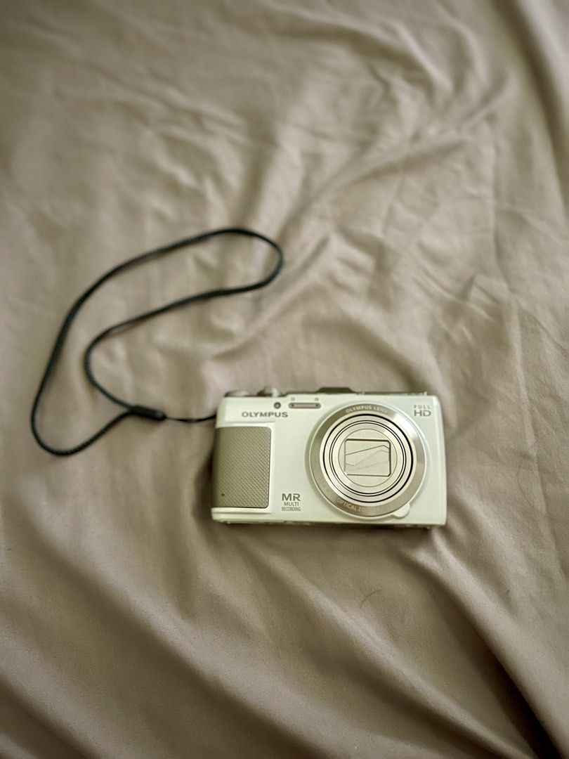 Olympus Stylus SH-25MR Digital Camera (Category: Cameras) located in Manila. Submitted by mysticbear.ad556f (Listing ID 1459597299, Image 1). Description: Key Specs: Sensor: 16 Megapixel, 1/2.3-inch Back-Illuminated CMOS Lens: 12.5x Wide Optical Zoom (4.2–52.5mm / 24–300mm equivalent in 35mm format), f/3.0–5.9 Display: 3.0-inch Touchscreen LCD (460,000 dots) Video Recording: Full HD 1080p video with simultaneous multi-recording (capturing photos 