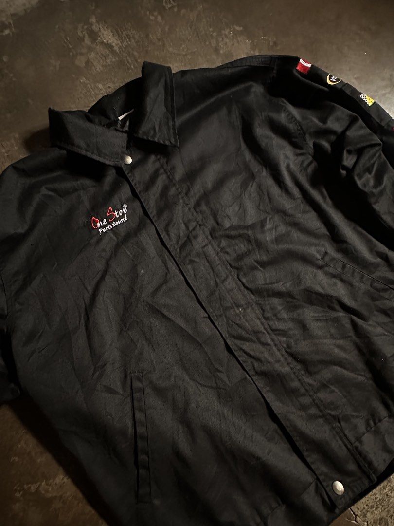 One Stop Parts Source Racing Jacket (Category: Coats, Jackets and Outerwear) located in Laoag. Submitted by keenforest-6bd6 (Listing ID 1459532581, Image 3). Description: - Black racing jacket from One Stop Parts Source. - Features embroidered patches on sleeves: Goodyear, Bendix, Delphi, Monroe. - Classic snap button closure. - Ideal for car enthusiasts and collectors..