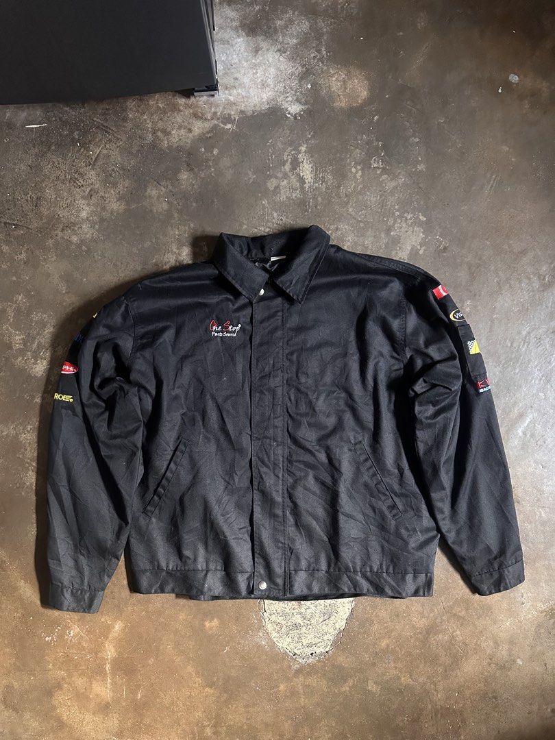 One Stop Parts Source Racing Jacket (Category: Coats, Jackets and Outerwear) located in Laoag. Submitted by keenforest-6bd6 (Listing ID 1459532581, Image 1). Description: - Black racing jacket from One Stop Parts Source. - Features embroidered patches on sleeves: Goodyear, Bendix, Delphi, Monroe. - Classic snap button closure. - Ideal for car enthusiasts and collectors..