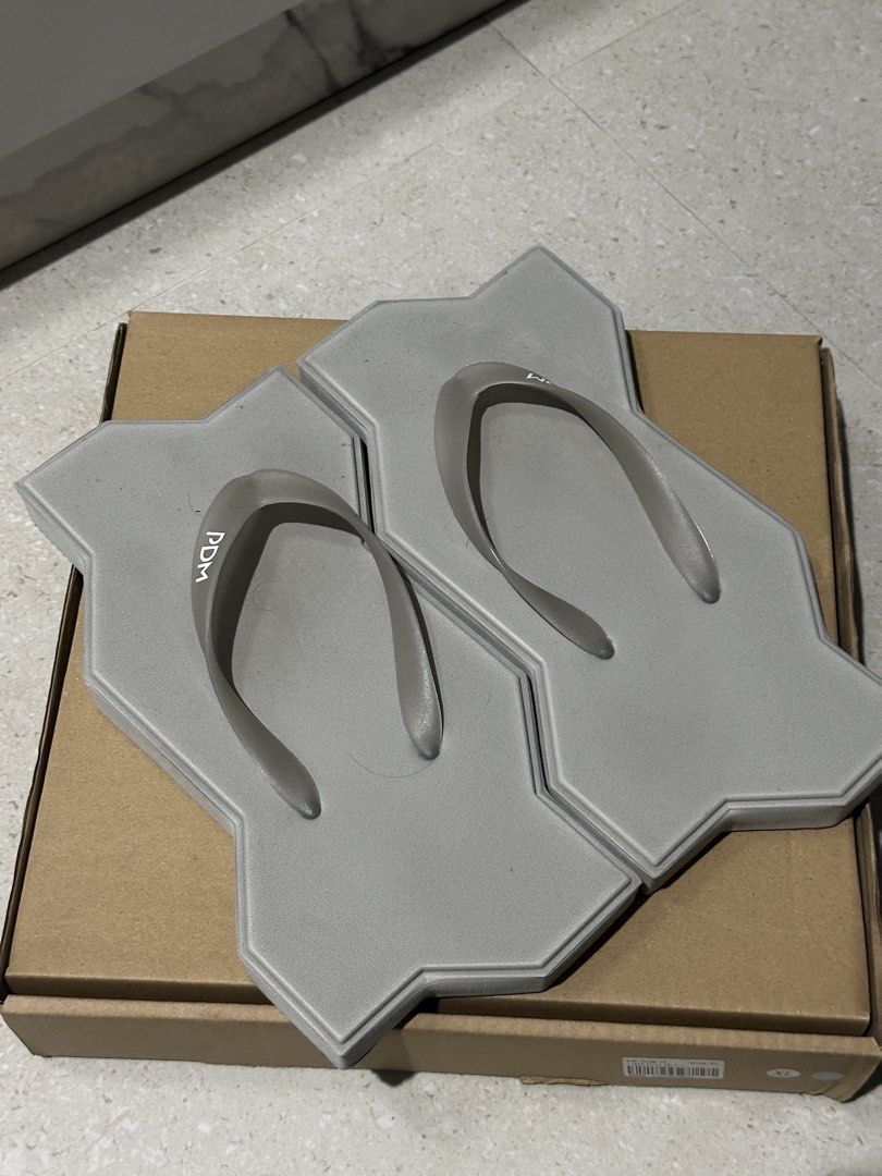 PDM Grey Unique Paving Stone Flip-flops (Category: Slippers and slides) located in Baguio. Submitted by miss_misery (Listing ID 1459653646, Image 1). Description: - Unique paving stone design in cool grey - Features the PDM logo on the straps - A definite conversation starter - Ideal for casual wear or as a novelty item - Limited stock available!.