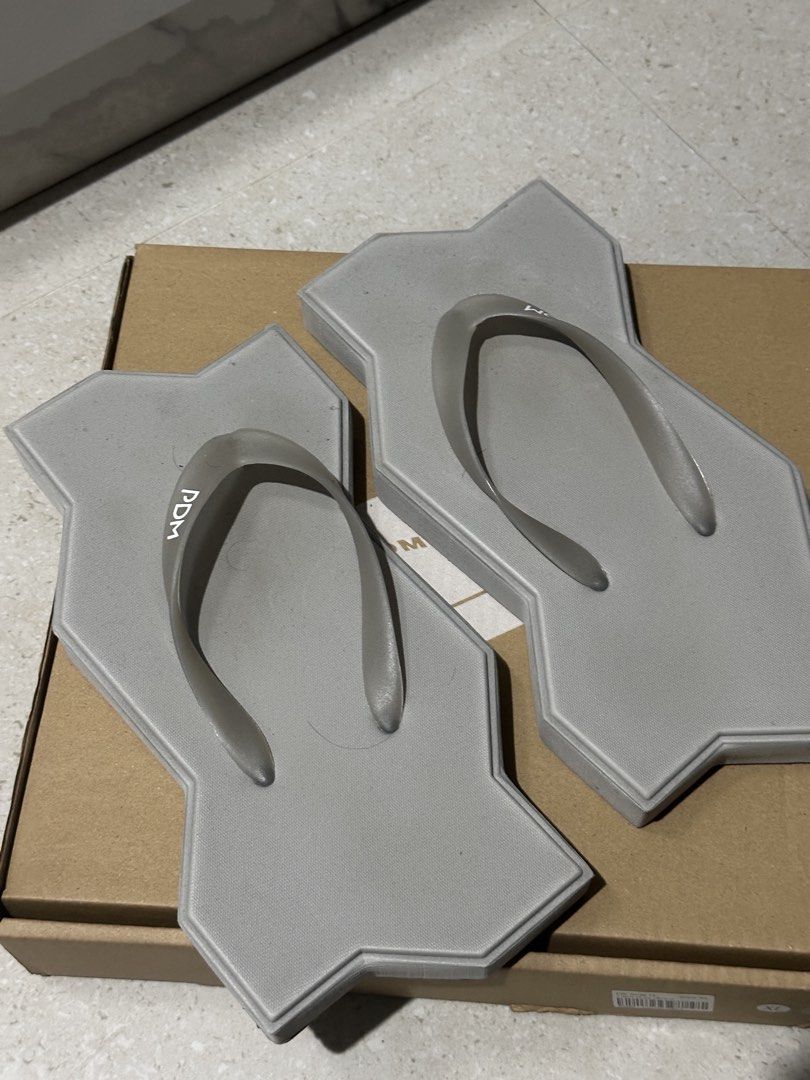 PDM Grey Unique Paving Stone Flip-flops (Category: Slippers and slides) located in Baguio. Submitted by miss_misery (Listing ID 1459653646, Image 2). Description: - Unique paving stone design in cool grey - Features the PDM logo on the straps - A definite conversation starter - Ideal for casual wear or as a novelty item - Limited stock available!.