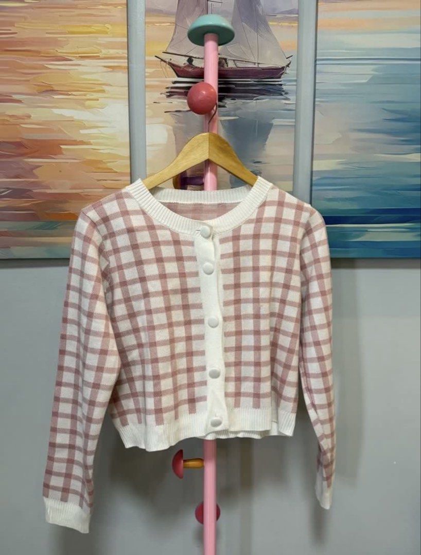 Pink and White Gingham Cropped Cardigan (Category: Coats, Jackets and Outerwear) located in Batangas. Submitted by melocollects (Listing ID 1459652454, Image 1). Description: - Cute pink and white gingham cropped cardigan - Button-up front - Ribbed hem and cuffs - Soft knit material - Perfect for layering over dresses or with high-waisted jeans - Achieves a casual, chic look.