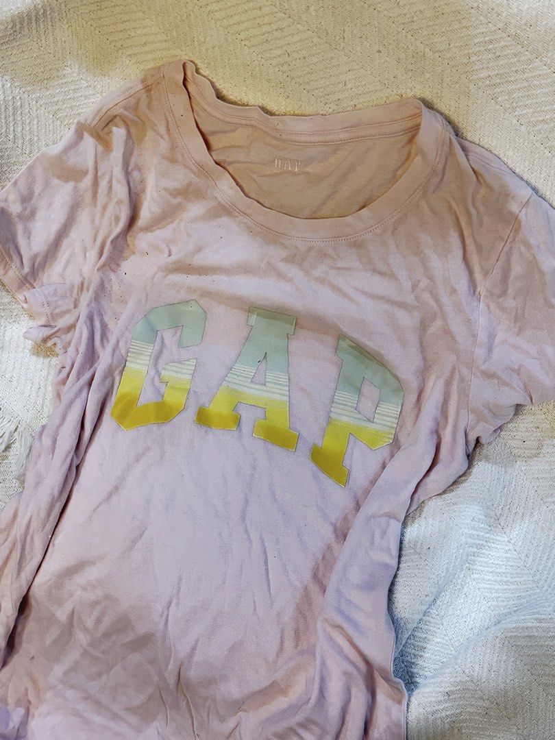 Pink GAP T-Shirt with Striped Logo (Category: Shirts) located in Abucay. Submitted by eripami (Listing ID 1459603030, Image 1). Description: - Brand: GAP - Color: Pink - Design: Classic GAP logo with yellow and light blue stripe - Sleeves: Short - Neckline: Crew neck - Style: Casual, comfortable, everyday wear - Pair with: Jeans or shorts will give for free if bought with another item listed! .