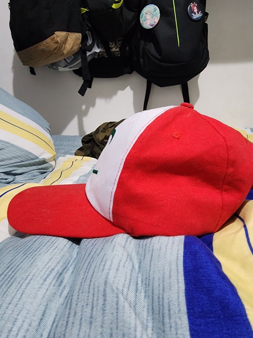 Pokemon Ash Ketchum Style Cap (Category: Caps & Hats) located in Meycauayan. Submitted by MP_Shop (Listing ID 1459577473, Image 2). Description: - Red and white cap - Green embroidery on the front - Yellow 'Pokemon' embroidery on the back - Adjustable strap with a metal buckle - Ideal for Pokemon enthusiasts.