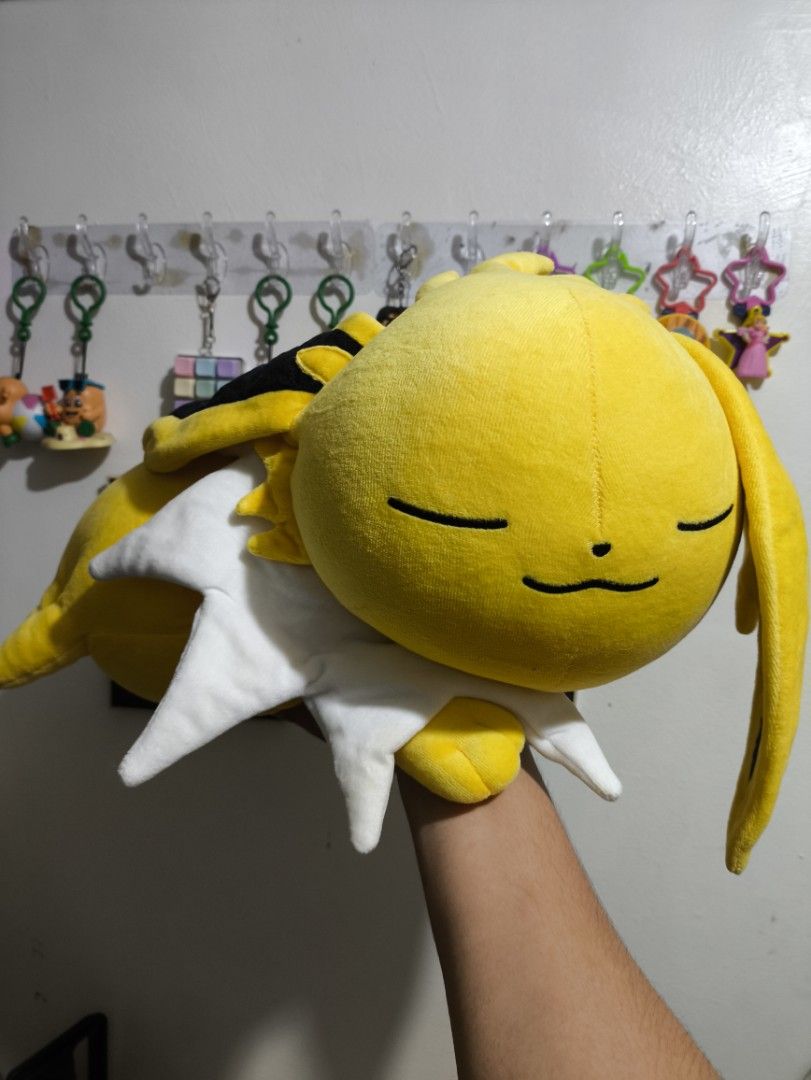 Pokemon Center Sleeping Jolteon (Category: Plushies & Soft Toys) located in Tigaon. Submitted by pikachaaan_ (Listing ID 1459616996, Image 1). Description: - Adorable yellow plush toy - Features a cute sleeping face with closed eyes and a small smile - Comes with a charming white collar - Incredibly soft and cuddly texture - Ideal for plush toy collectors - Makes a wonderful gift for any occasion.