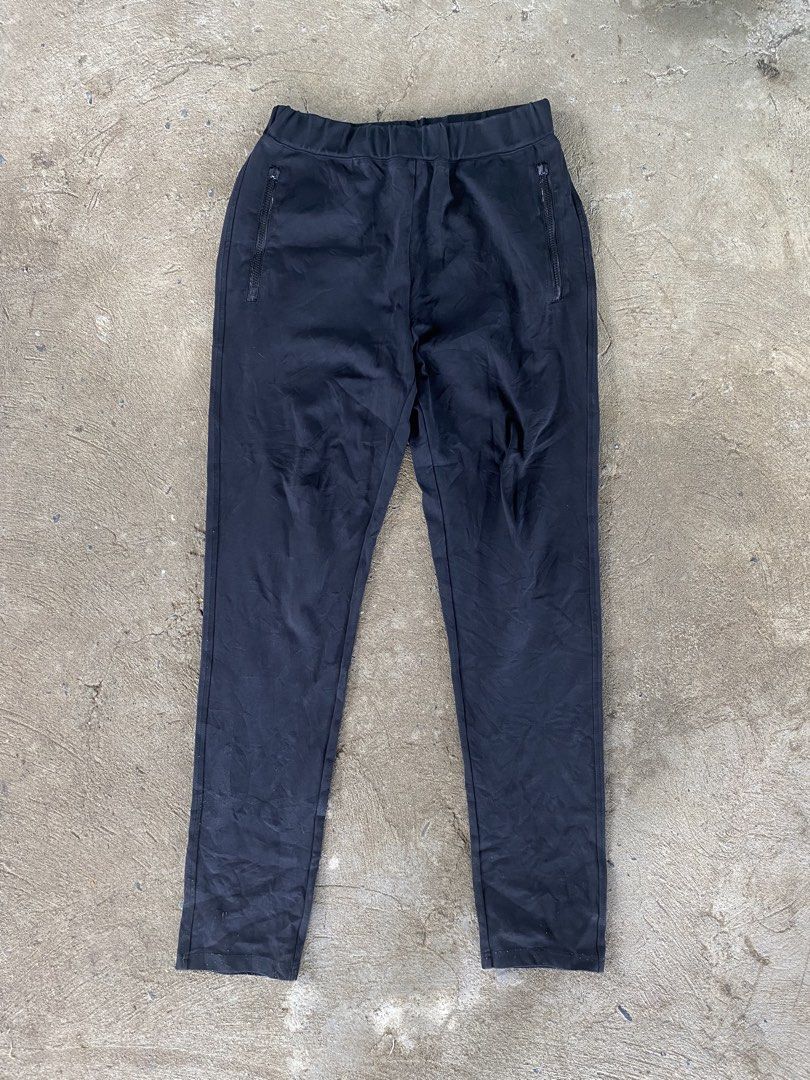 Prada Black Nylon Track Pants Joggers Size XL (Category: Joggers) located in Sinait. Submitted by rinzuthrift (Listing ID 1459528895, Image 2). Description: - Authentic Prada track pants - Size: XL - Material: Nylon and polyester blend - Features: Elastic waistband with drawstring, zipped front pockets - Iconic Prada triangle logo on the back pocket - Perfect for stylish casual wear - Missing zip puller.