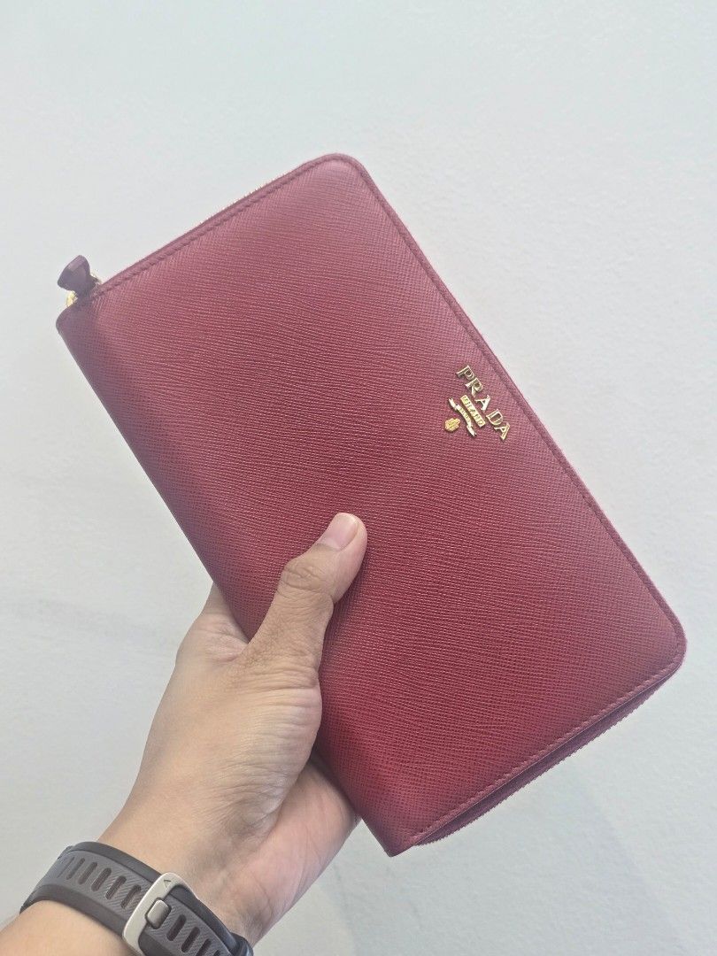 Prada Fuoco Saffiano Leather Long Wallet (Category: Luxury Bags & Wallets) located in Taguig. Submitted by mluxeph (Listing ID 1459534104, Image 2). Description: Prada Fuoco Saffiano Leather Long Wallet Gender: Unisex Material: Saffiano leather Stamp: 230 / 1ML188 Interior: Twelve card slots, one gusseted compartment, one pen holder, one document pocket and two bill compartments Measurements: 8.4”L X 0.9”W X 4.75”H Handle Drop: None Hardware: Gol
