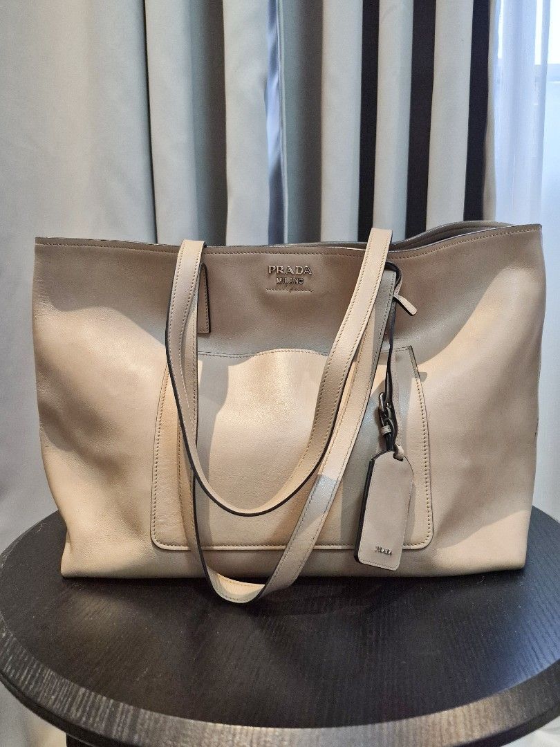 Prada Milano Beige Leather Tote Bag (Category: Luxury Bags & Wallets) located in Manila. Submitted by unknowncloset (Listing ID 1459579073, Image 1). Description: - Light beige Prada tote bag - Made of soft, supple leather - Convenient front pocket - Two comfortable straps - Includes authentic Prada leather tag - Ample interior space for all your essentials - Ideal for daily use.