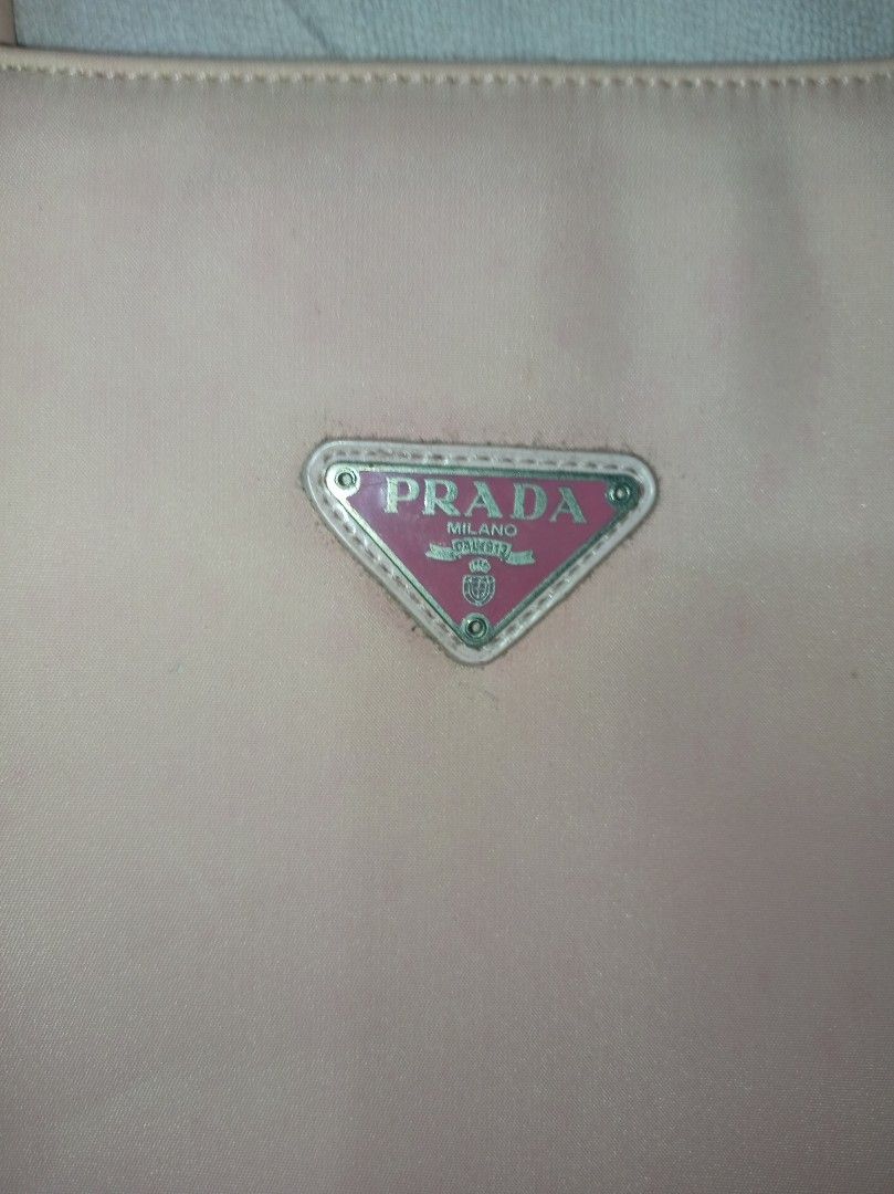 Prada Pink nylon bag (Category: Luxury Bags & Wallets) located in Malolos. Submitted by shoptokyothrift (Listing ID 1459559482, Image 3). Description: Vintage Prada Milano Pink Nylon Tote 🩷 Classic Prada Milano nylon tote with signature triangular logo, pink Prada lining & zip closure. Pre-loved/vintage with visible stains, discoloration and signs of use — please check all photos carefully. Please check photos/details before buying. Sold as is. 