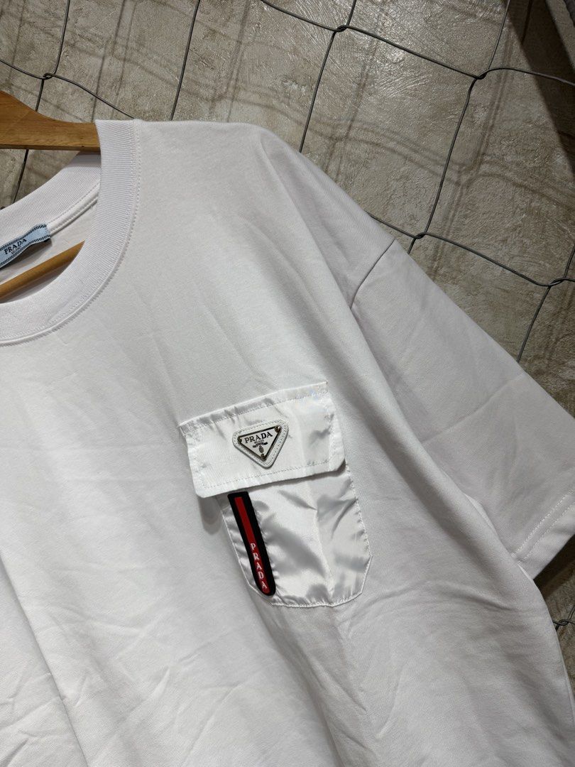 Prada White Pocket T-Shirt (Category: Tshirts & Polo Shirts ) located in Manila. Submitted by ardobe.mnl (Listing ID 1459638813, Image 3). Description: Prada Plate Logo White Pocket Tee. Size: XXL Dimes: 24x30 Condition: Good asnew Flaw: None! Dm for inquiries! 🛒📥.