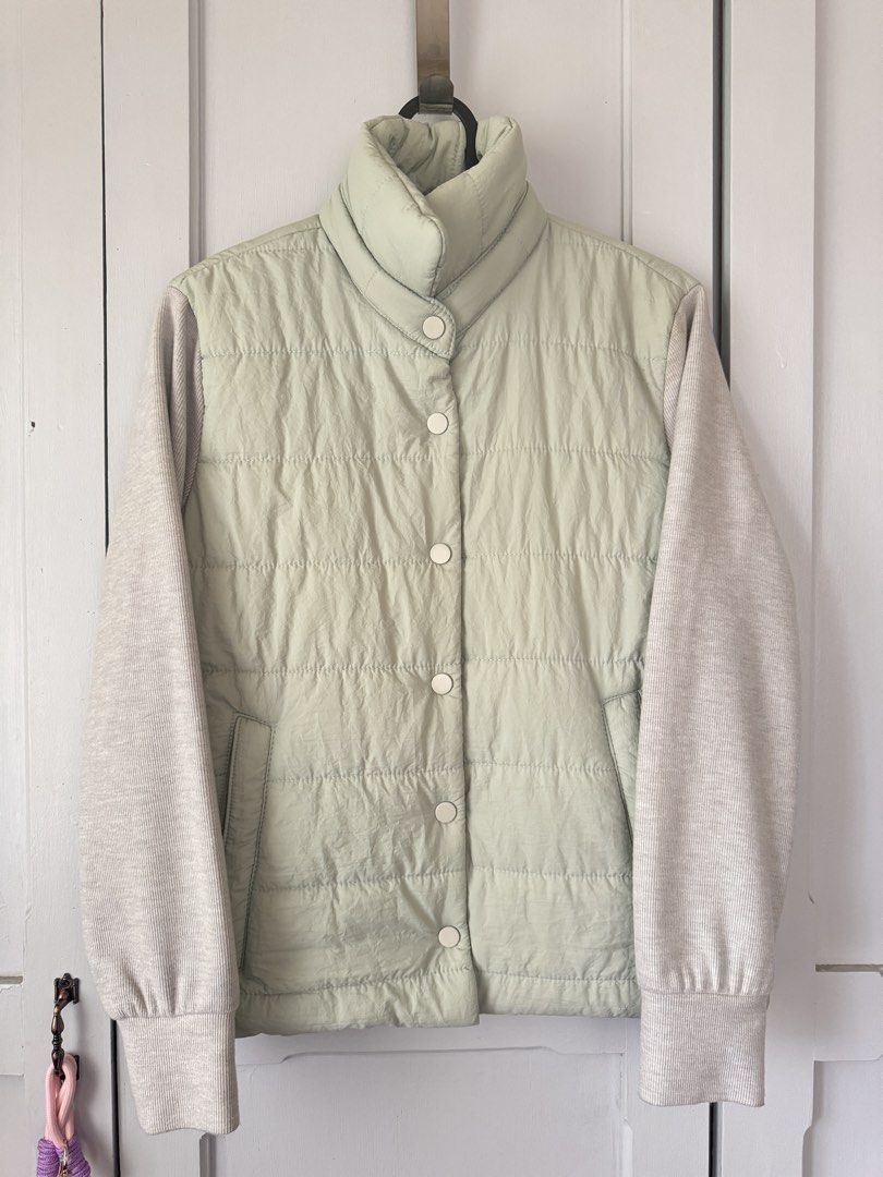 Puffer Jacket with Knit Sleeves (Category: Coats, Jackets and Outerwear) located in Baguio. Submitted by makemegeli (Listing ID 1459539297, Image 1). Description: Lightweight puffer jacket from na.mu. Features a pale green quilted body and contrasting knit sleeves. Snap button closure down the front. Elasticated drawstring at the waist for a cinched look. Two front pockets. Great layering piece for cooler weather..
