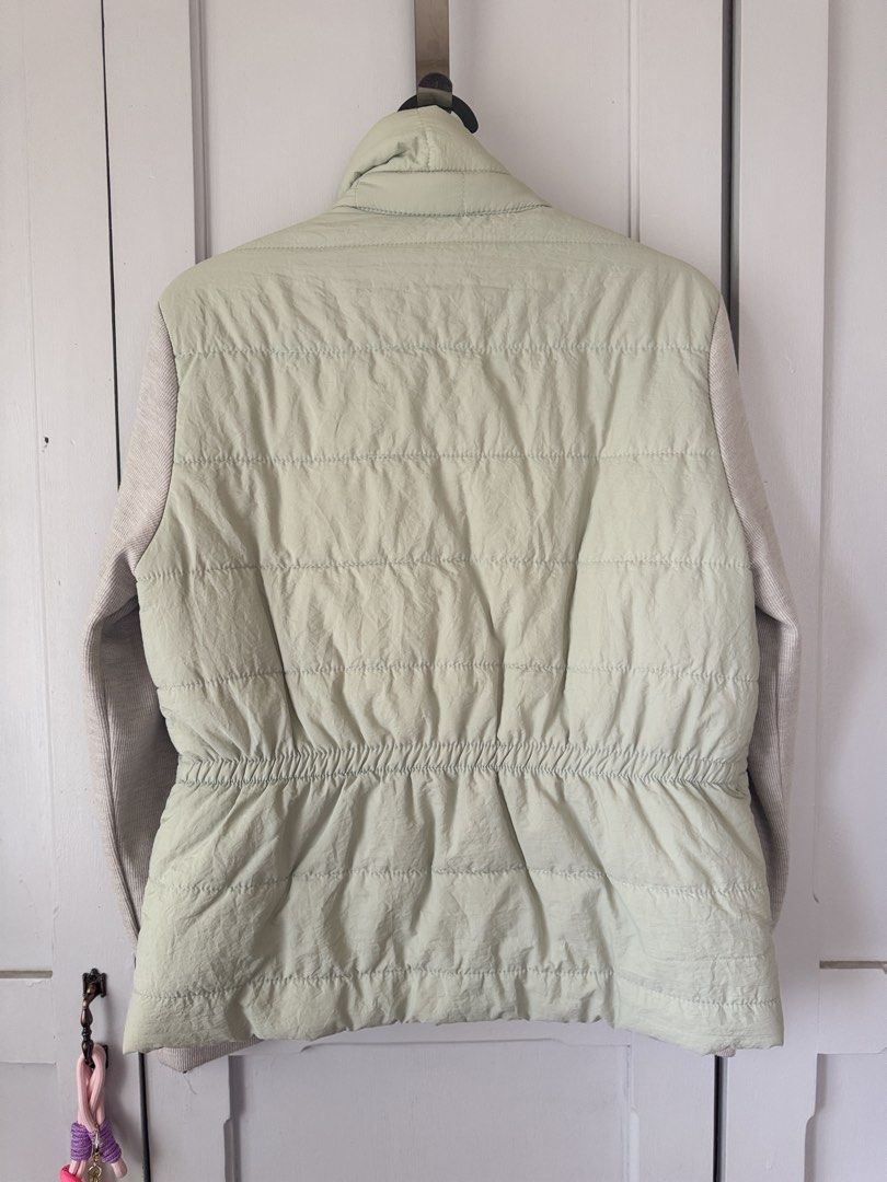 Puffer Jacket with Knit Sleeves (Category: Coats, Jackets and Outerwear) located in Baguio. Submitted by makemegeli (Listing ID 1459539297, Image 2). Description: Lightweight puffer jacket from na.mu. Features a pale green quilted body and contrasting knit sleeves. Snap button closure down the front. Elasticated drawstring at the waist for a cinched look. Two front pockets. Great layering piece for cooler weather..