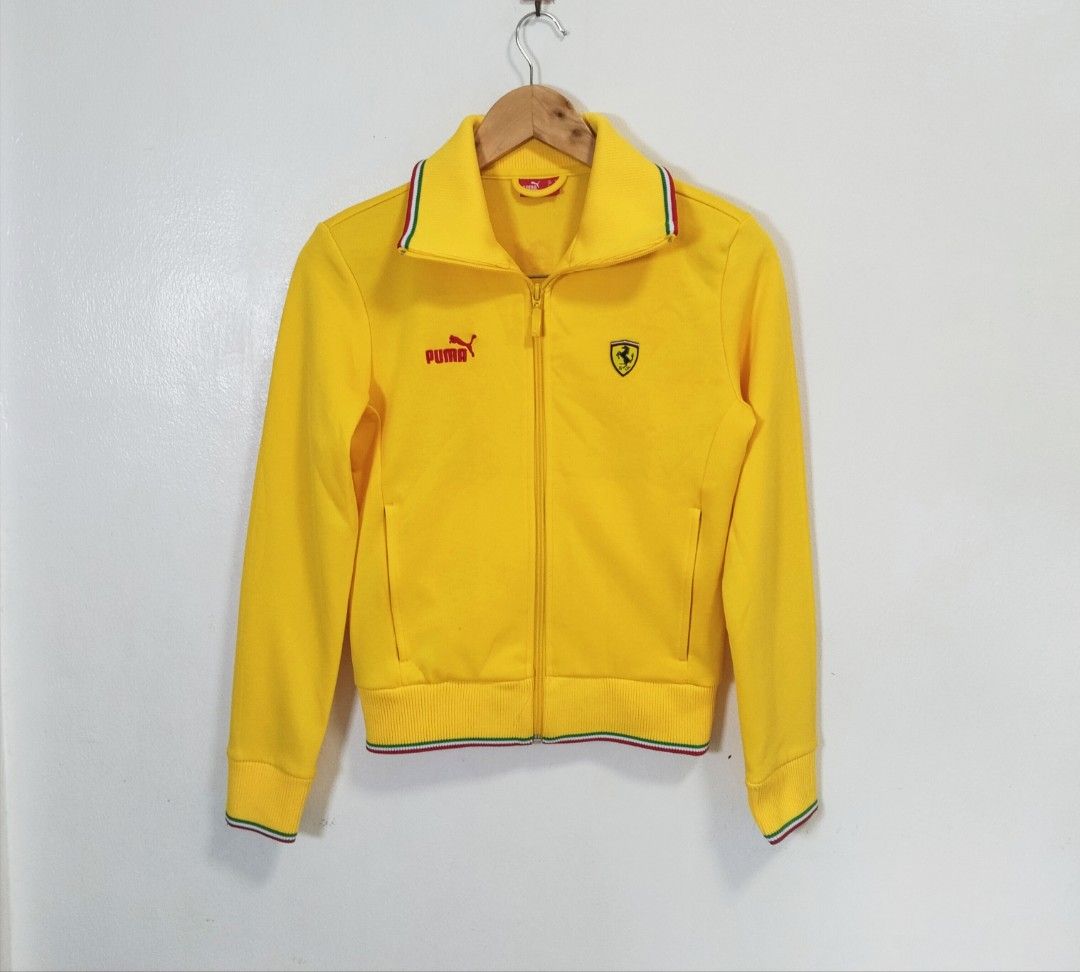 Puma Ferrari Track Jacket (Category: Coats, Jackets and Outerwear) located in Pateros City. Submitted by blashjunks.y2k (Listing ID 1459555927, Image 3). Description: Cool yellow Puma Ferrari track jacket. Features the Ferrari shield logo on the front and back. "Campioni" text with Puma logo on the back. Ribbed collar, cuffs, and hem with red, white, and green stripes. Zip-up front. Great for any Ferrari or Puma fan..