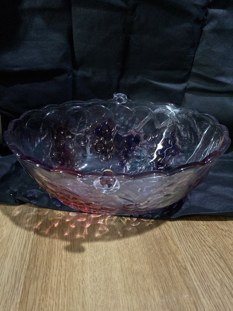 Purple Grape Embossed Glass Serving Bowl (Category: Other Kitchenware & Tableware) located in Taguig. Submitted by cosmickindle (Listing ID 1459569578, Image 1). Description: - Stunning purple glass serving bowl - Elegant grape and leaf embossed design around the rim - Delicate scalloped edge detail - Ideal for serving fruits, salads, or as a decorative centerpiece - Adds a vibrant pop of color to your table - Convenient handles on each side for 