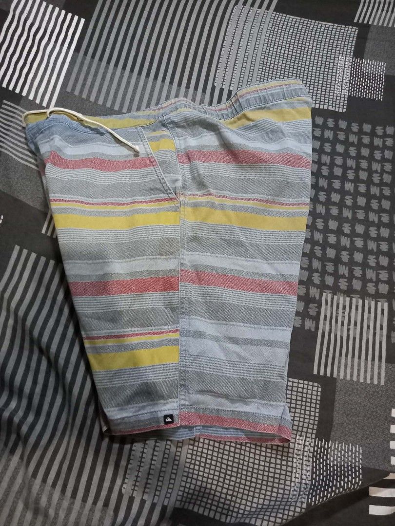 Quiksilver Striped Board Shorts (Category: Swim Trunks & Board Shorts) located in Panabo. Submitted by khimmyirish_ki021126 (Listing ID 1459539022, Image 3). Description: - Quiksilver board shorts - Grey base with yellow, red, and blue stripe pattern - Elastic waistband with drawstring - Side pockets - Ideal for beach or pool - Measurements available in photos.