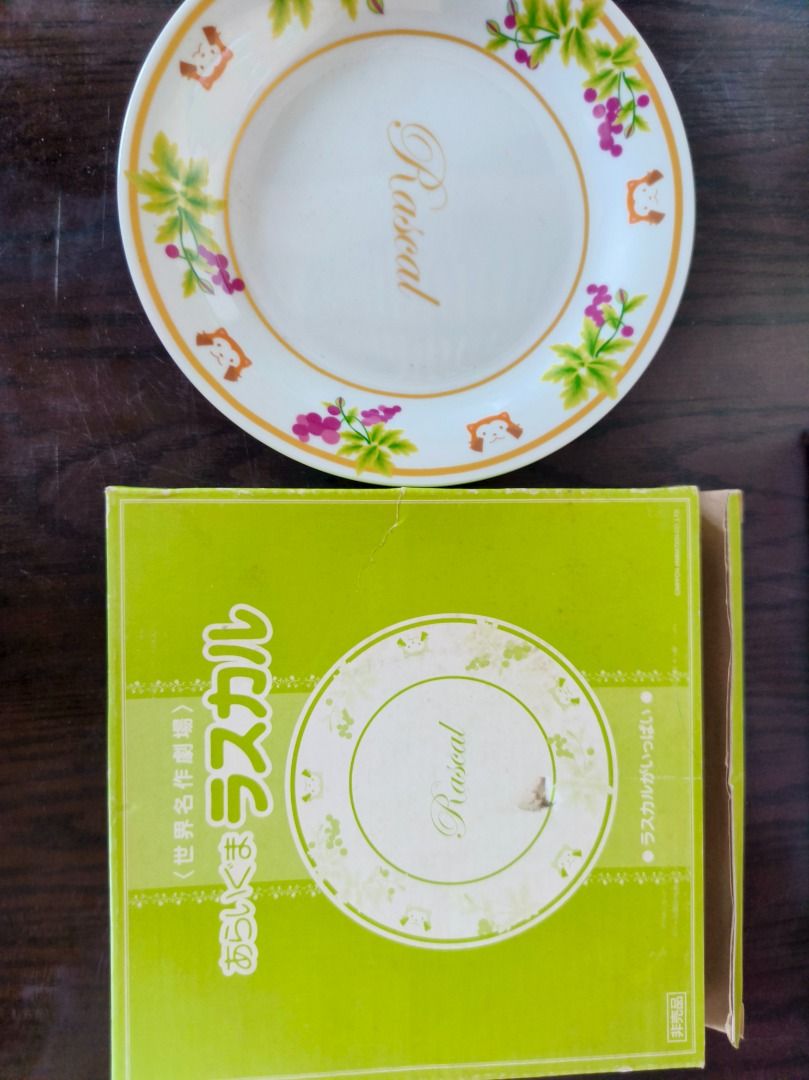 Rascal Limited Collection Nippon Animation Plate (Category: Dinnerware & Cutlery) located in San Leonardo. Submitted by burgossanleonardo.12345 (Listing ID 1459539070, Image 3). Description: - Limited Collection Rascal Plate - Features cute illustrations of Rascal and grapes - 'Rascal' is written in the center - From Nippon Animation Co., Ltd. - Marked 'Not for Sale' - Comes in its original box.