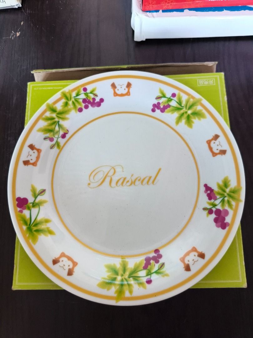 Rascal Limited Collection Nippon Animation Plate (Category: Dinnerware & Cutlery) located in San Leonardo. Submitted by burgossanleonardo.12345 (Listing ID 1459539070, Image 1). Description: - Limited Collection Rascal Plate - Features cute illustrations of Rascal and grapes - 'Rascal' is written in the center - From Nippon Animation Co., Ltd. - Marked 'Not for Sale' - Comes in its original box.