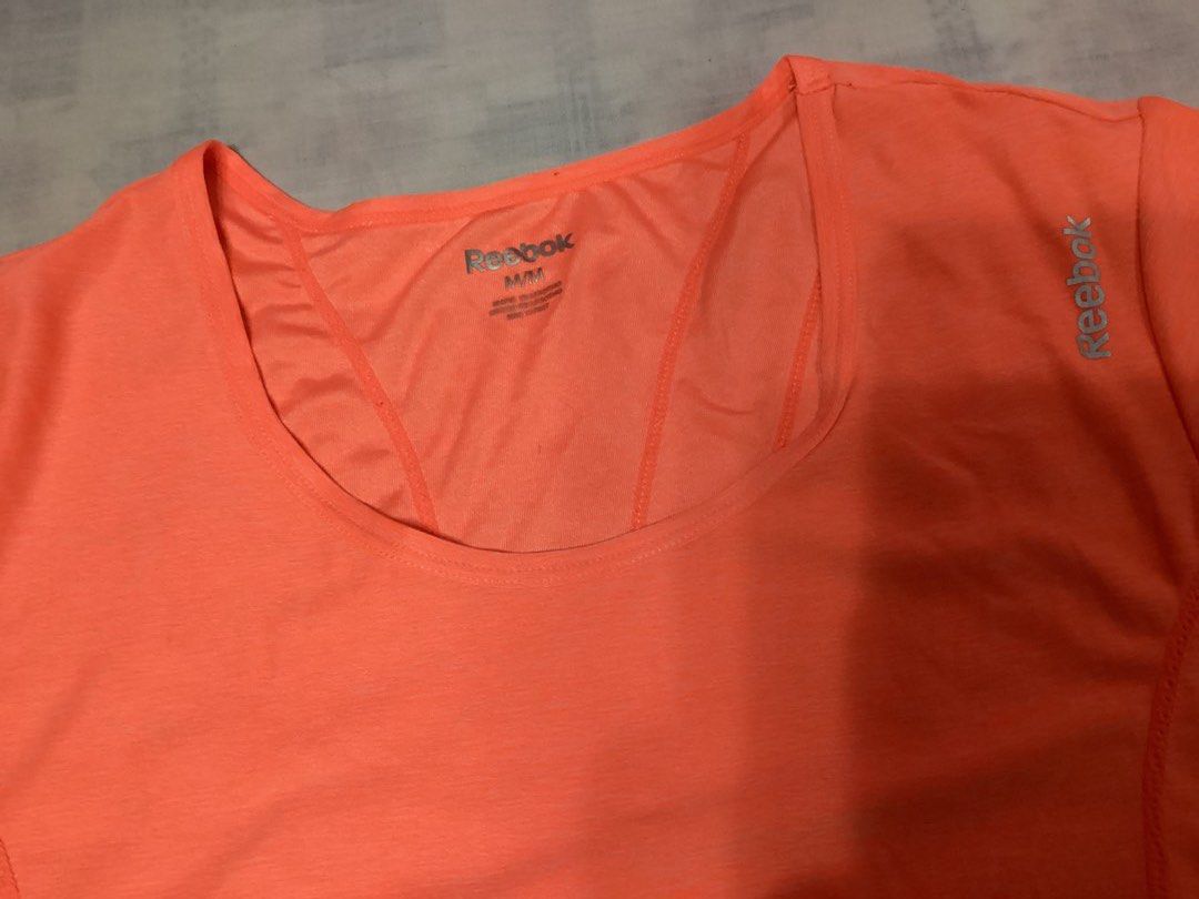 Reebok Orange Athletic T-shirt (Category: Activewear) located in Davao. Submitted by ferdipt (Listing ID 1418779982, Image 2). Description: Designed for training & fitness For Women Size: M Made in Lesotho 96% Polyester, 4% Spandex.