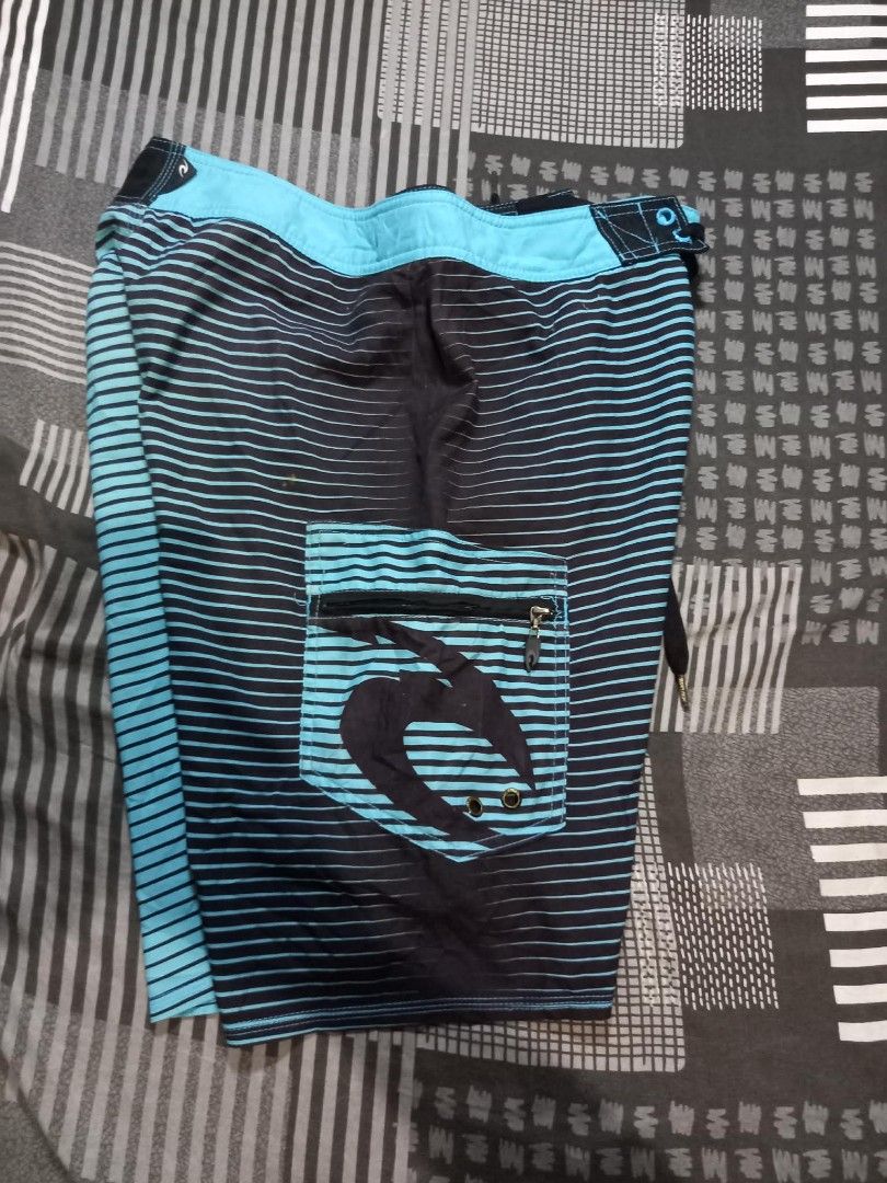 Rip Curl Board Shorts Size 30 Blue Black Stripe (Category: Swim Trunks & Board Shorts) located in Panabo. Submitted by khimmyirish_ki021126 (Listing ID 1459551039, Image 2). Description: - Rip Curl board shorts - Size 30 - Blue and black stripe pattern - Back pocket with zip closure - Drawstring waist - Ideal for swimming or surfing.