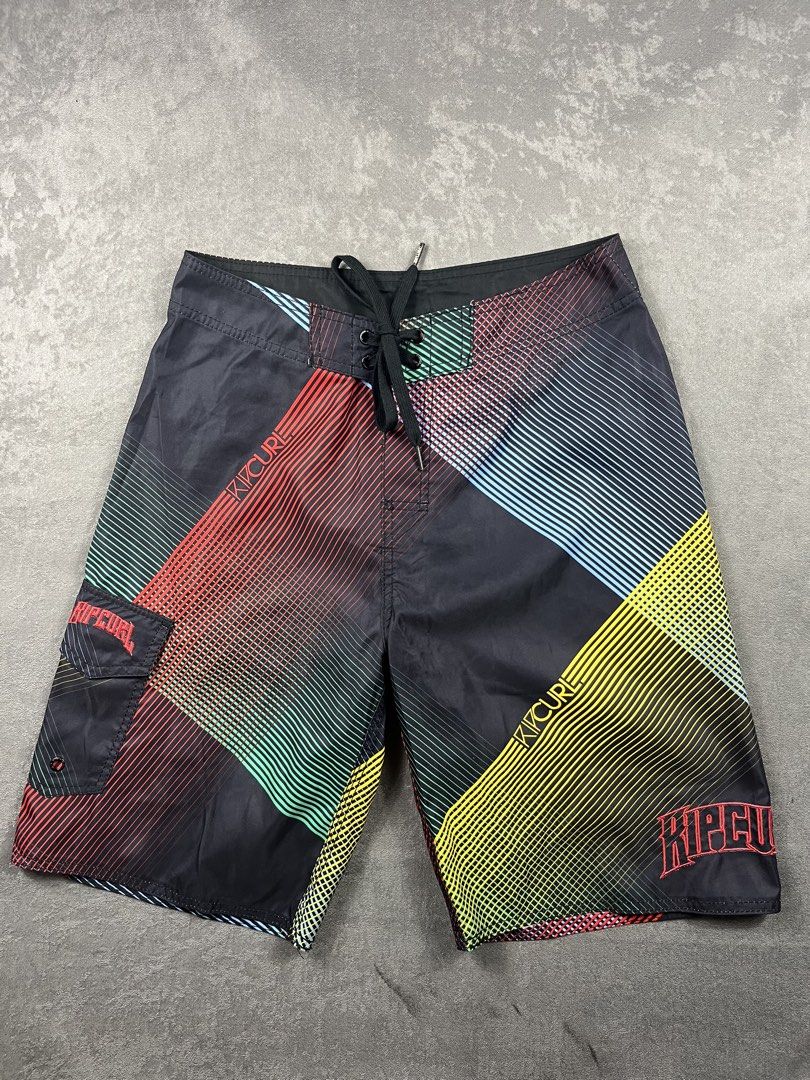Rip Curl Men's Board Shorts Size 30 (Category: Swim Trunks & Board Shorts) located in Manila. Submitted by homegrwn_thrift (Listing ID 1459639451, Image 1). Description: - Brand: Rip Curl - Size: 30 fits to 33 - Color: Black with colorful geometric stripe pattern - Features: Drawstring waist, velcro back pocket - Ideal for: Swimming, surfing, beach trips.