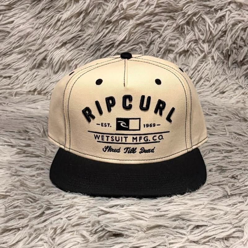 Ripcurl Snapback Cap - Wetsuit Mfg. Co. (Category: Caps & Hats) located in Santa Rosa. Submitted by klarksantos (Listing ID 1459600626, Image 1). Description: - Classic Ripcurl snapback cap - Beige crown with black brim - Features 'Wetsuit Mfg. Co.' logo and 'Shred Till Dead' text - Adjustable snapback closure for a comfortable fit - Ideal for casual wear, beach days, or a surf-inspired look.