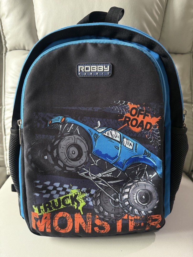 Robby Rabbit Monster Truck & Dinosaur Reversible Backpack (Category: Babies & Kids Fashion) located in Quezon City. Submitted by master_yaj (Listing ID 1459538987, Image 2). Description: - Fun Robby Rabbit backpack for kids - Features cool monster truck and dinosaur designs - Side mesh pockets for water bottles - Comfortable padded shoulder straps - Ideal for school, day trips, and adventures.