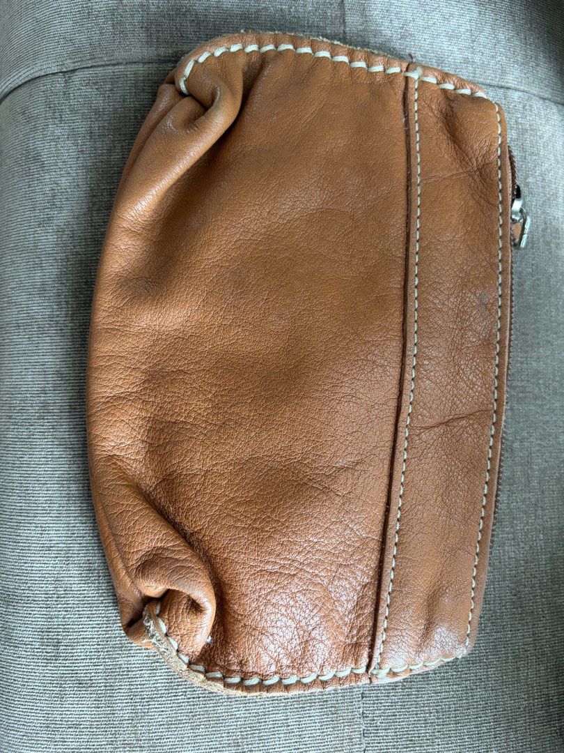Roots Leather Pouch Wristlet Tan (Category: Purses & Pouches) located in Taguig. Submitted by styledamsel (Listing ID 1459530759, Image 2). Description: - Genuine Roots tan leather pouch - Detachable wrist strap included - Secure zipper closure - Ideal for organizing small essentials - Compact size fits easily into larger bags.