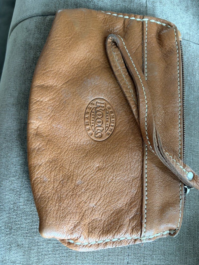 Roots Leather Pouch Wristlet Tan (Category: Purses & Pouches) located in Taguig. Submitted by styledamsel (Listing ID 1459530759, Image 1). Description: - Genuine Roots tan leather pouch - Detachable wrist strap included - Secure zipper closure - Ideal for organizing small essentials - Compact size fits easily into larger bags.