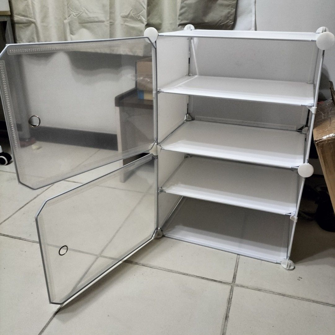 Shoe Cabinet 4-Tier White Modular Storage Organizer (Category: Shelves, Cabinets & Racks) located in Paranaque City. Submitted by decluttering-all (Listing ID 1459500301, Image 2). Description: - White modular shoe cabinet with 4 tiers. - Each cube features a door with a circular handle. - Easy to assemble and customize to fit your space. - Ideal for organizing shoes, bags, or other small items. - Helps keep your entryway neat and tidy. - Comes w