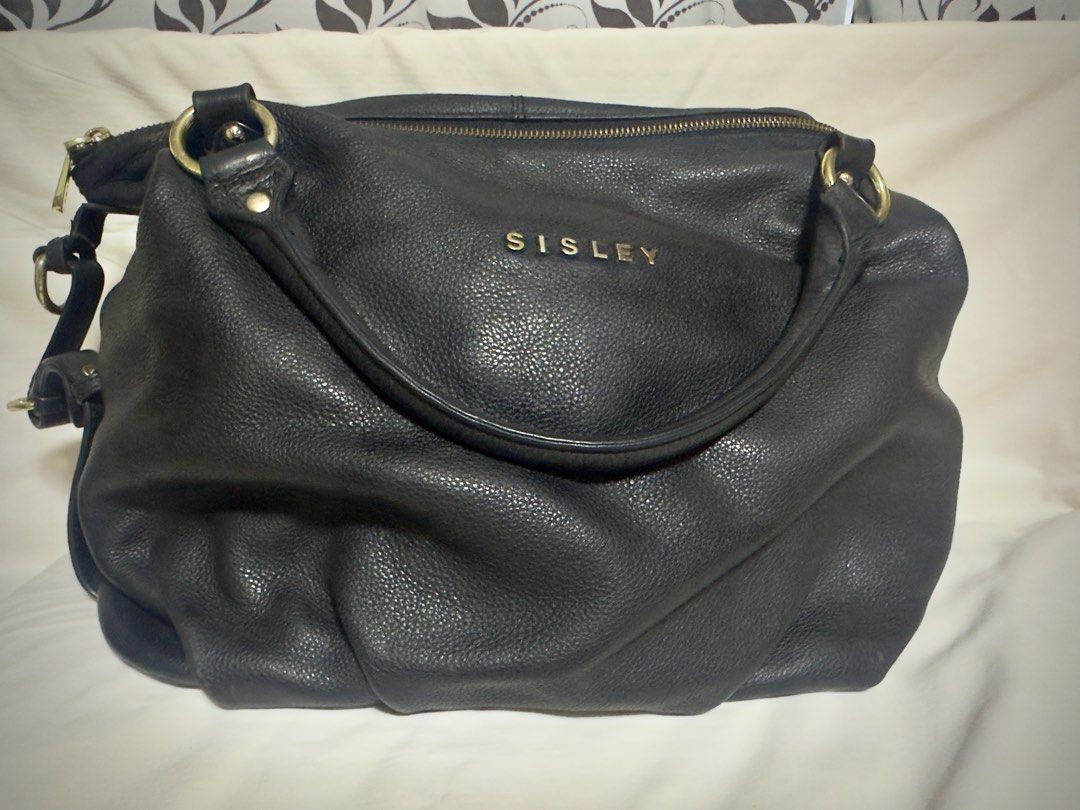 SISLEY Black Leather Shoulder Bag (Category: Shoulder Bags) located in Paranaque City. Submitted by hazmineme65412 (Listing ID 1459585549, Image 1). Description: - Brand: SISLEY - Material: Textured black leather - Hardware: Gold-tone - Closure: Main zip compartment - Interior: Pockets for organization - Style: Slouchy, relaxed shoulder bag - Ideal for: Everyday use - flaws shown in the pictures - No long handle.