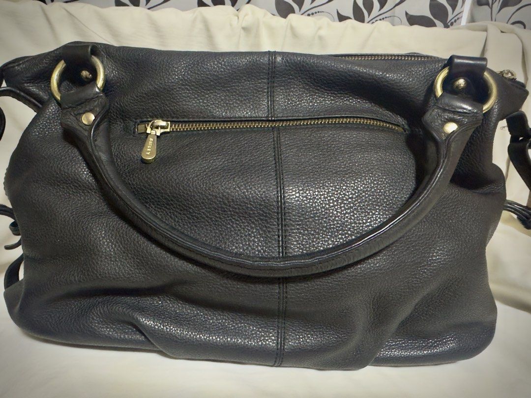 SISLEY Black Leather Shoulder Bag (Category: Shoulder Bags) located in Paranaque City. Submitted by hazmineme65412 (Listing ID 1459585549, Image 2). Description: - Brand: SISLEY - Material: Textured black leather - Hardware: Gold-tone - Closure: Main zip compartment - Interior: Pockets for organization - Style: Slouchy, relaxed shoulder bag - Ideal for: Everyday use - flaws shown in the pictures - No long handle.