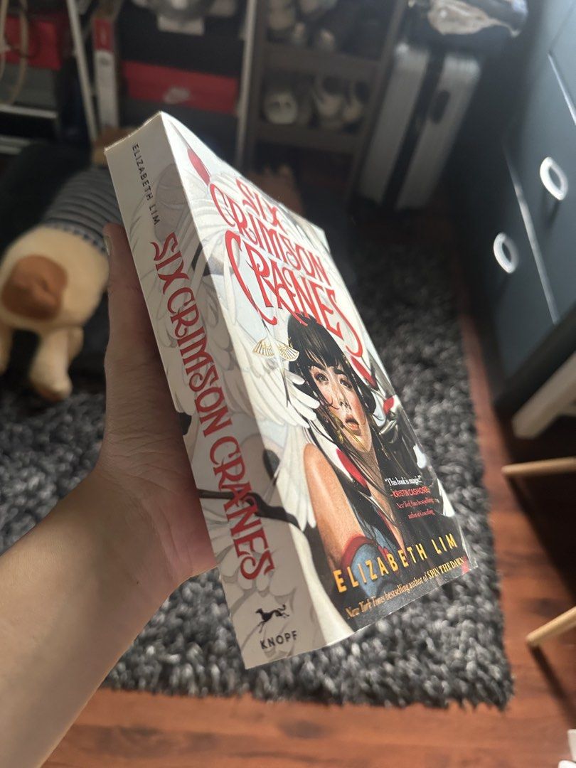 Six Crimson Cranes by Elizabeth Lim (Category: Storybooks) located in Binan City. Submitted by denchimmy (Listing ID 1459545569, Image 2). Description: - Fantasy novel by Elizabeth Lim - Features a princess in exile, a shapeshifting dragon, and enchanted cranes - Story of Princess Shiori'anma and a dangerous secret - Her stepmother, a sorceress, curses her brothers into cranes - Shiori must remain silent to prevent her brothers' deaths.