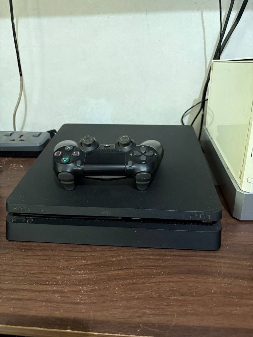 Sony PlayStation 4 Slim Console with Controller and Games (Category: PlayStation) located in Binan City. Submitted by vryb3rryy (Listing ID 1459507669, Image 1). Description: Selling a black PS4 Slim console. Includes one DualShock 4 controller. Games shown are included: NBA 2K19, NBA 2K17, Lego Jurassic World, The Walking Dead: The Complete First Season, God of War III Remastered, Disney Pixar Toy Story 3, Wipeout Pure, Monster Hunter Portable, 