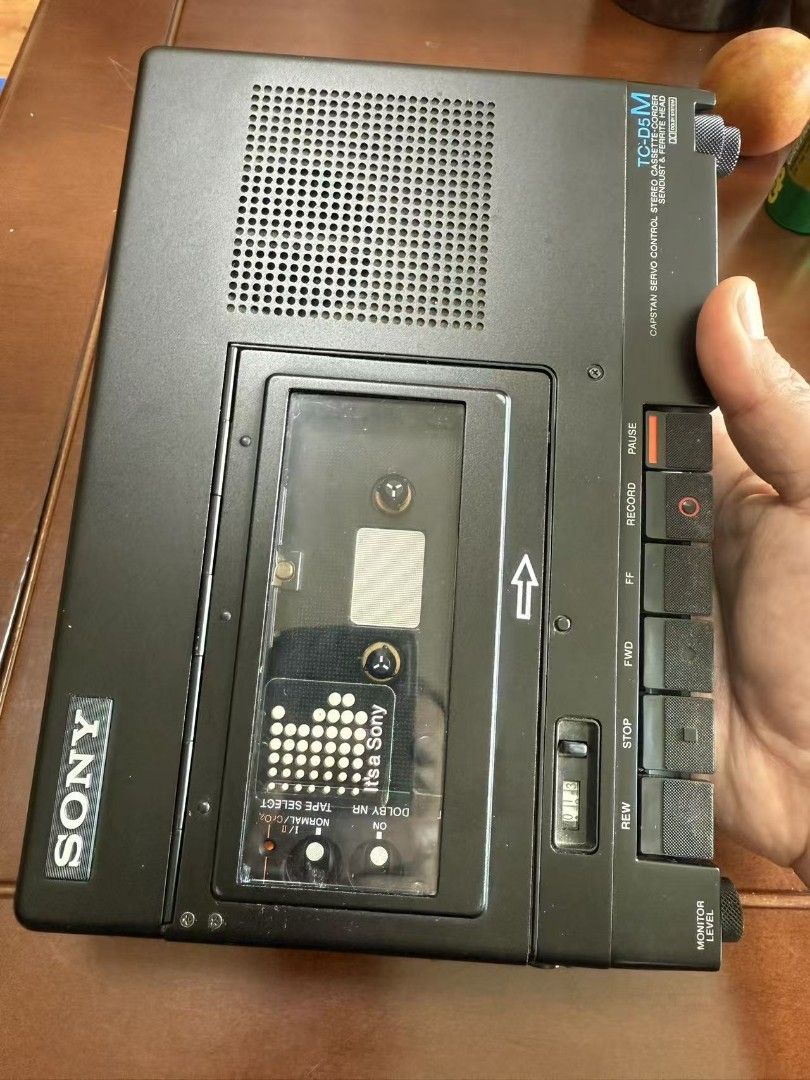 Sony TC-D5M 錄音機 （分類：錄音機）位於 Hong Kong。 由 kentpath2 提交（商品編號 1459687418，圖片 1）。簡介： Sony TC-D5M 是索尼在 1980 年代推出的傳奇級專業立體聲卡式錄放機，被廣泛應用於廣播採訪與現場錄音。 核心特點與設計雙錶頭設計：面板上標誌性的左右聲道「大眼睛」VU 錶頭，可精確即時顯示錄音與播放的音量峰值。卓越走帶系統：採用具備慣性飛輪的精密機械結構，確保戶外或移動中播放與錄音的轉速極度穩定。支援多種磁帶：支援四種不同類型的卡式磁帶（包括 Normal、CrO2、Metal 金屬帶），並內建 Dolby B 杜比降噪系統。專業與便利介面：配備 6.35mm 非平衡麥克風輸入插孔、Line Out 線路輸出，以及便於現場監聽的內建單聲道喇叭。 音質與收藏價值模擬巔峰：音質溫暖細緻，具備極高的動態表現，被許多音頻發燒友視為模擬音訊時代的標杆。。