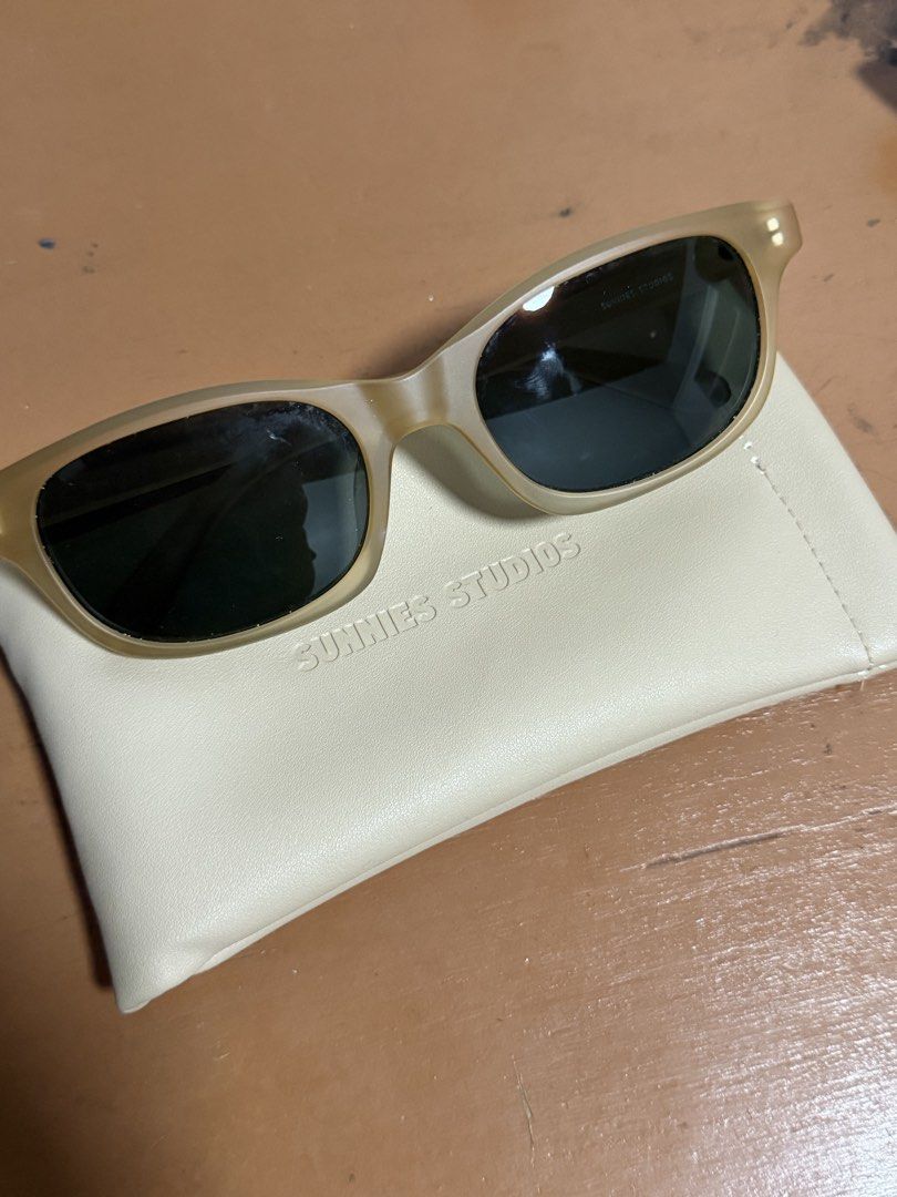 Sunnies Studios Sunglasses with Case (Category: Sunglasses & Eyewear) located in Cainta. Submitted by Samyy (Listing ID 1459619658, Image 1). Description: Light brown/tan colored sunglasses. Comes with a cream colored pouch. The pouch has 'SUNNIES STUDIOS' embossed on it. The sunglasses also have the brand name on the inside of the arm. Great for everyday wear. Wrong size :( .