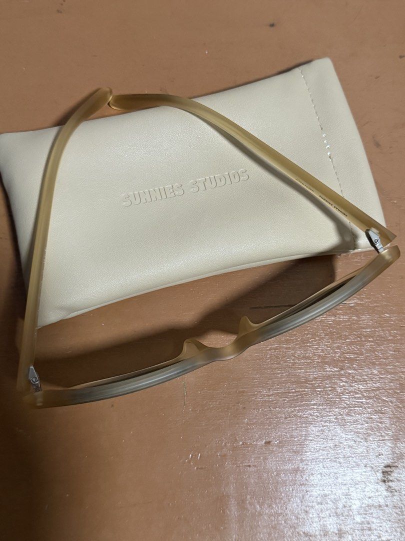 Sunnies Studios Sunglasses with Case (Category: Sunglasses & Eyewear) located in Cainta. Submitted by Samyy (Listing ID 1459619658, Image 2). Description: Light brown/tan colored sunglasses. Comes with a cream colored pouch. The pouch has 'SUNNIES STUDIOS' embossed on it. The sunglasses also have the brand name on the inside of the arm. Great for everyday wear. Wrong size :( .